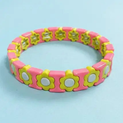 Pink and yellow floral-patterned bracelet on a light blue background