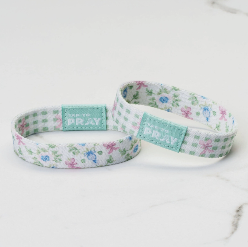 Two floral-patterned wristbands with &