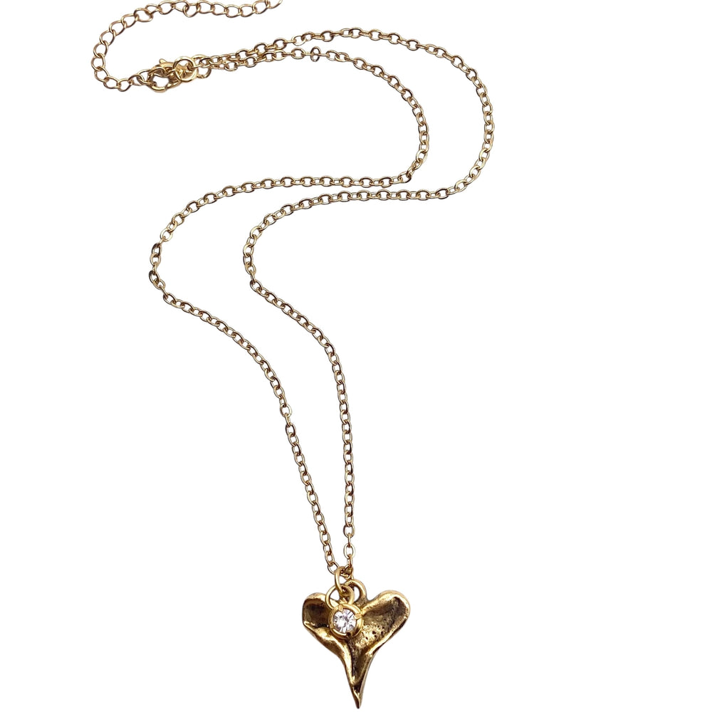 Gold necklace with a heart-shaped pendant on a white background