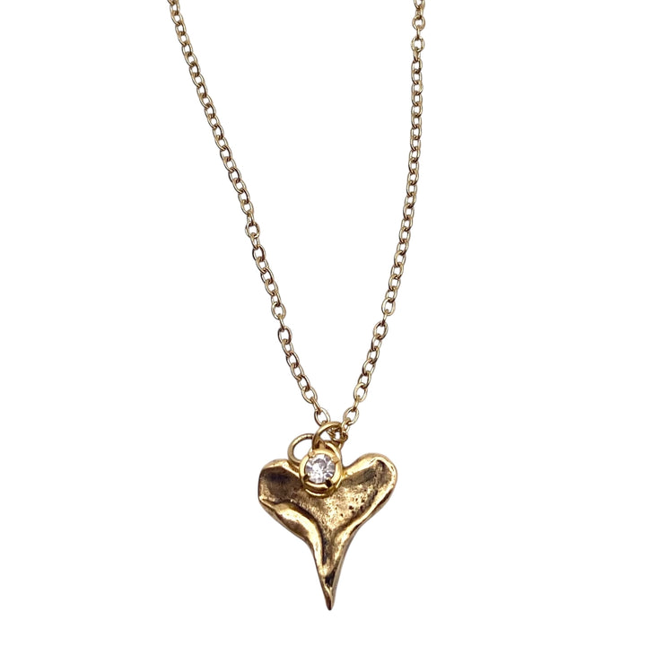 Gold necklace with a heart-shaped pendant on a white background