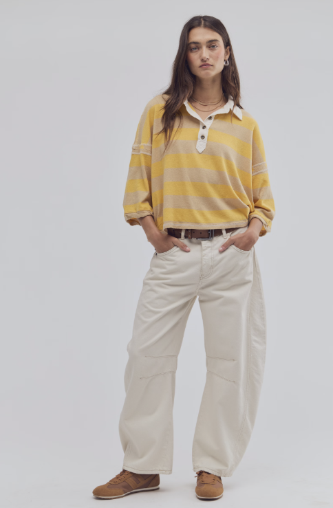 Person wearing a yellow striped shirt and beige pants on a white background
