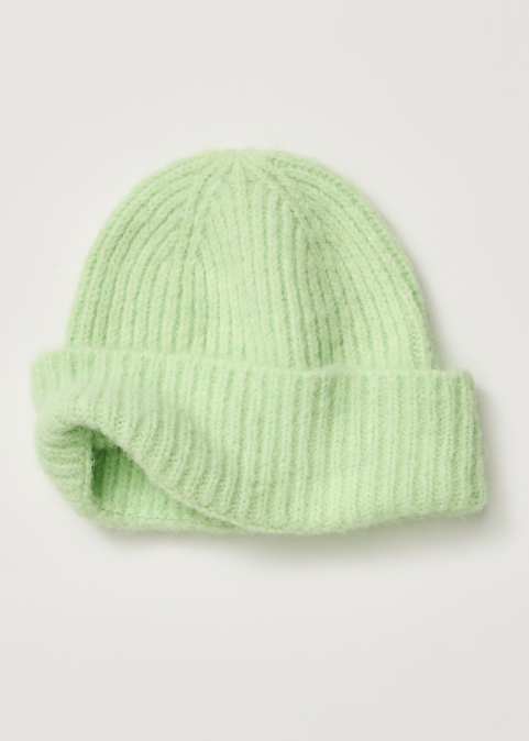 Single green beanie on plain background