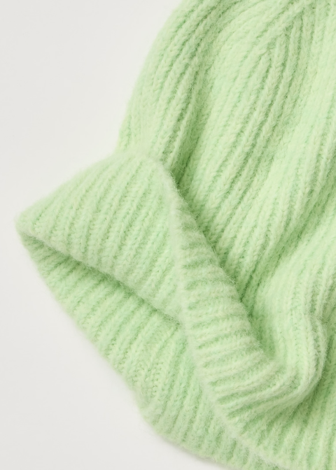 A close-up of a light mint green ribbed knit fabric, showing the soft texture and folded edges on a plain white background.