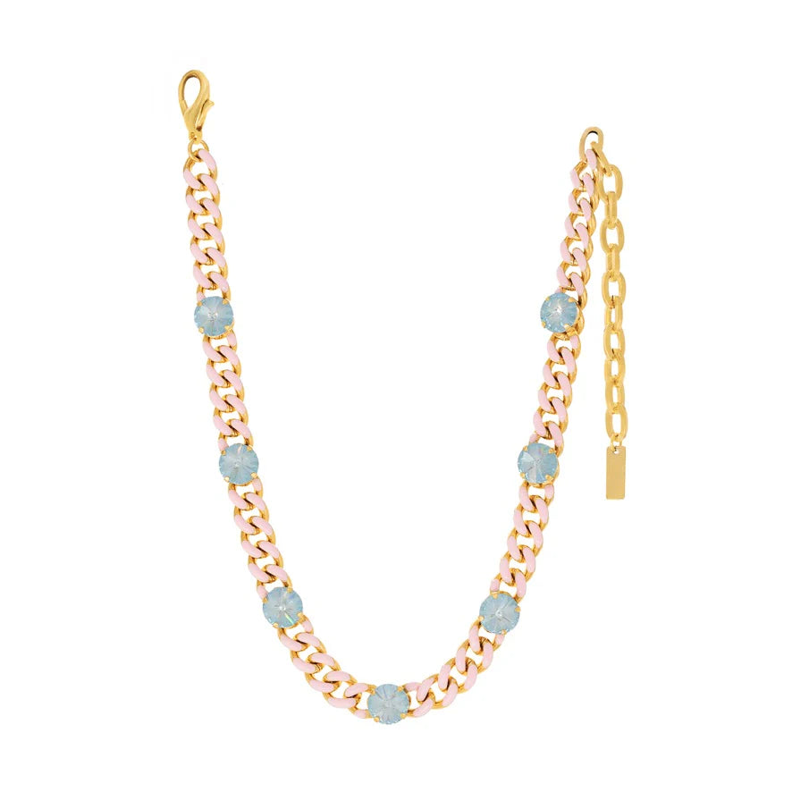 Pink and gold enamel necklace with blue crystal on white background