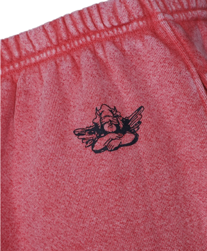 Red fabric with a black embroidered design on a white background