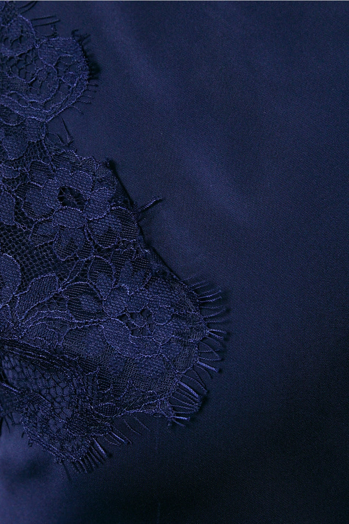 Navy blue fabric with lace detailing on a matching background