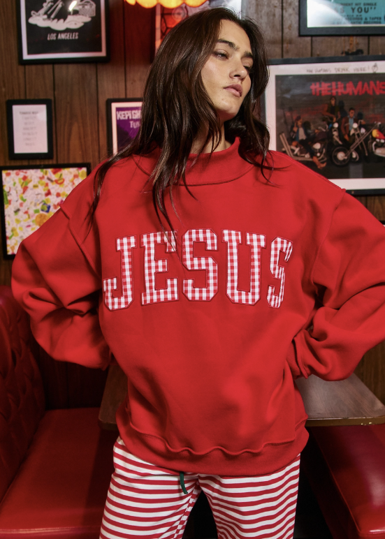 Woman wearing red mock neck sweatshirt with gingham &