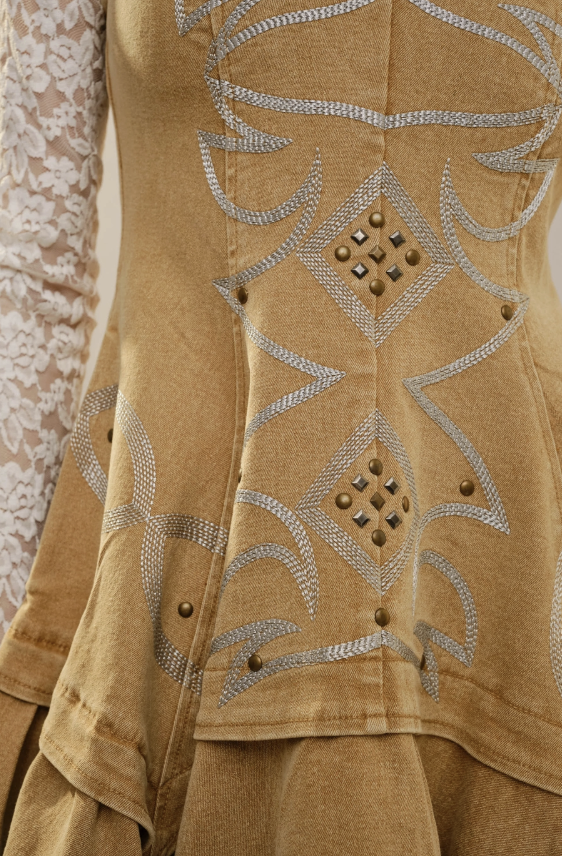 Brown embroidered garment with decorative patterns on a floral background