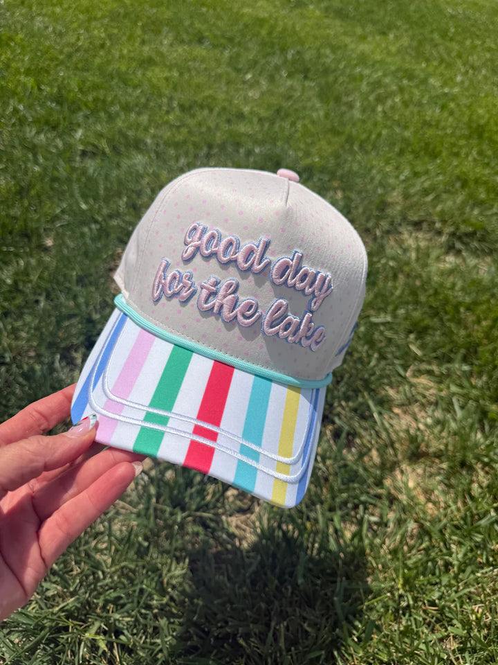Hand holding hat embroidered with &
