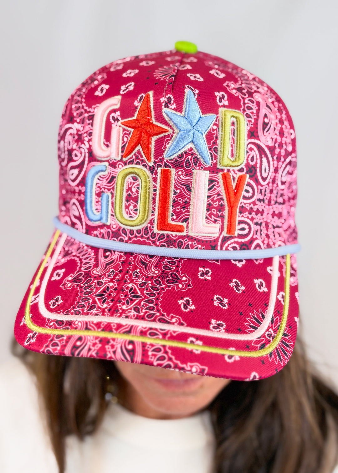 Woman wearing maroon bandana print trucker hat with &