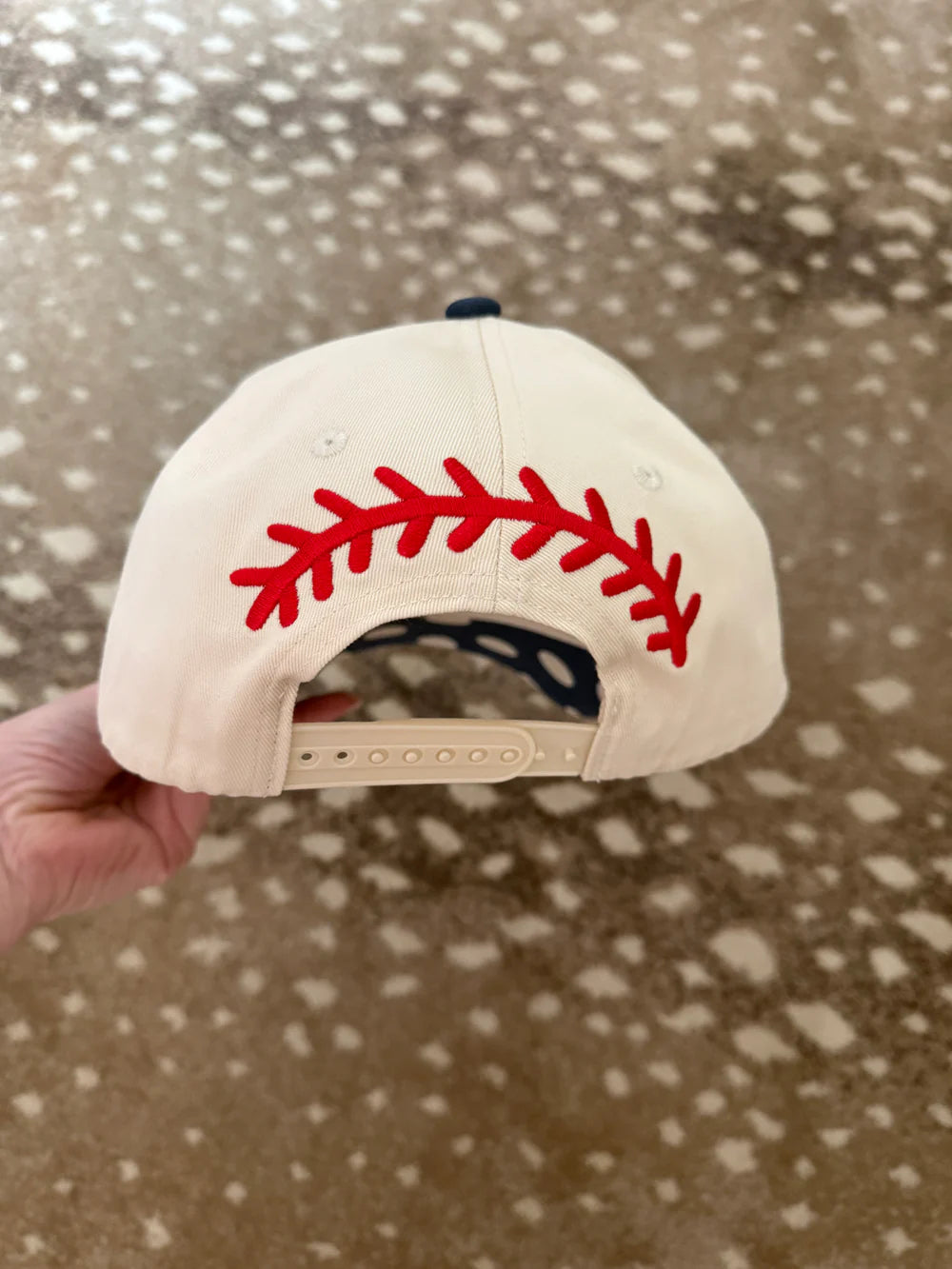 back of trucker hat with baseball stitching on pattern background