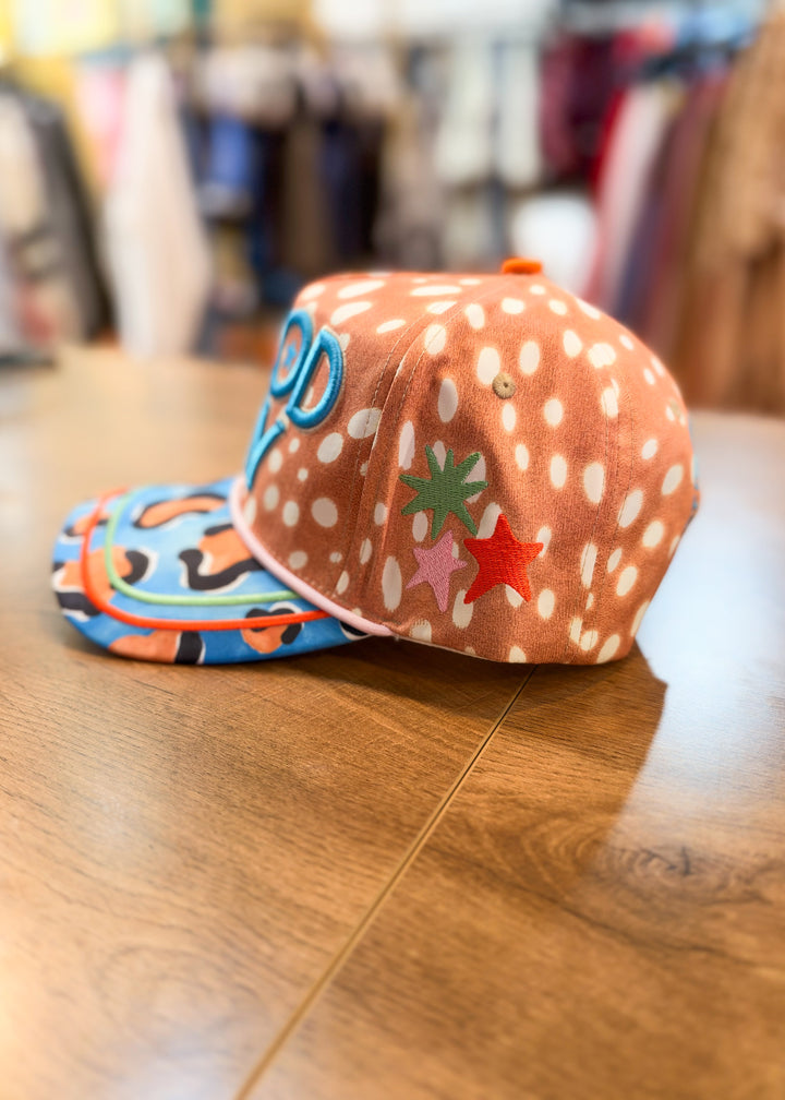 Fawn print trucker hat with stars embroidered on side, blue leopard bill and &