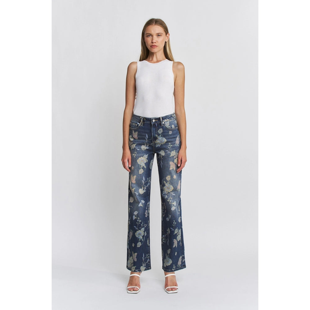 Woman wearing floral-patterned jeans on a white background