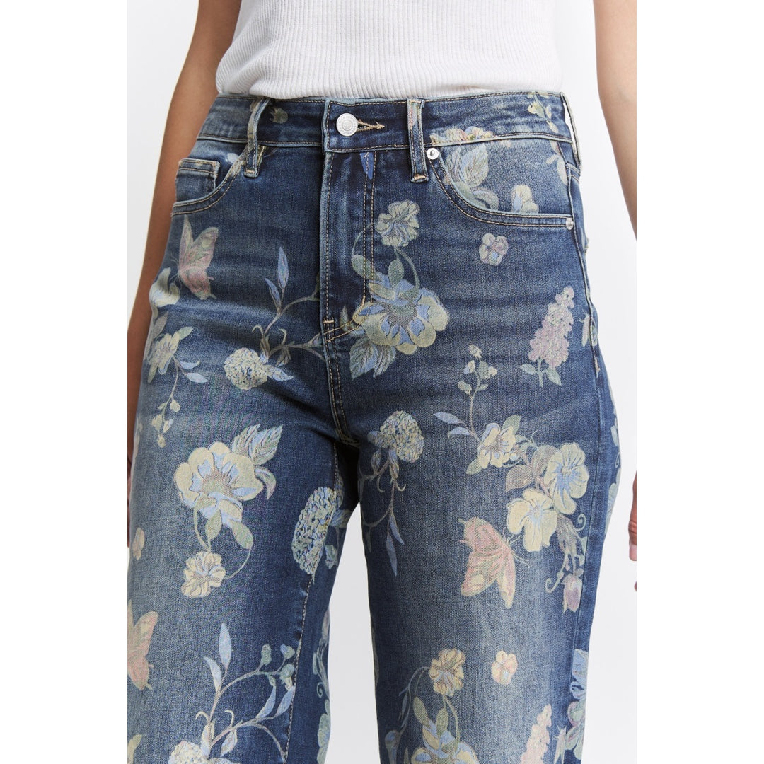 Floral-patterned jeans worn by a person on a white background