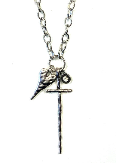 Silver chain necklace with cross, heart and crystal pendant on it on white background