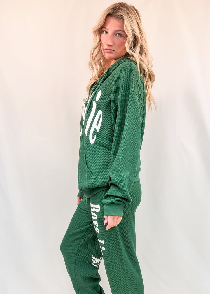 Woman wearing matching green set on plain background