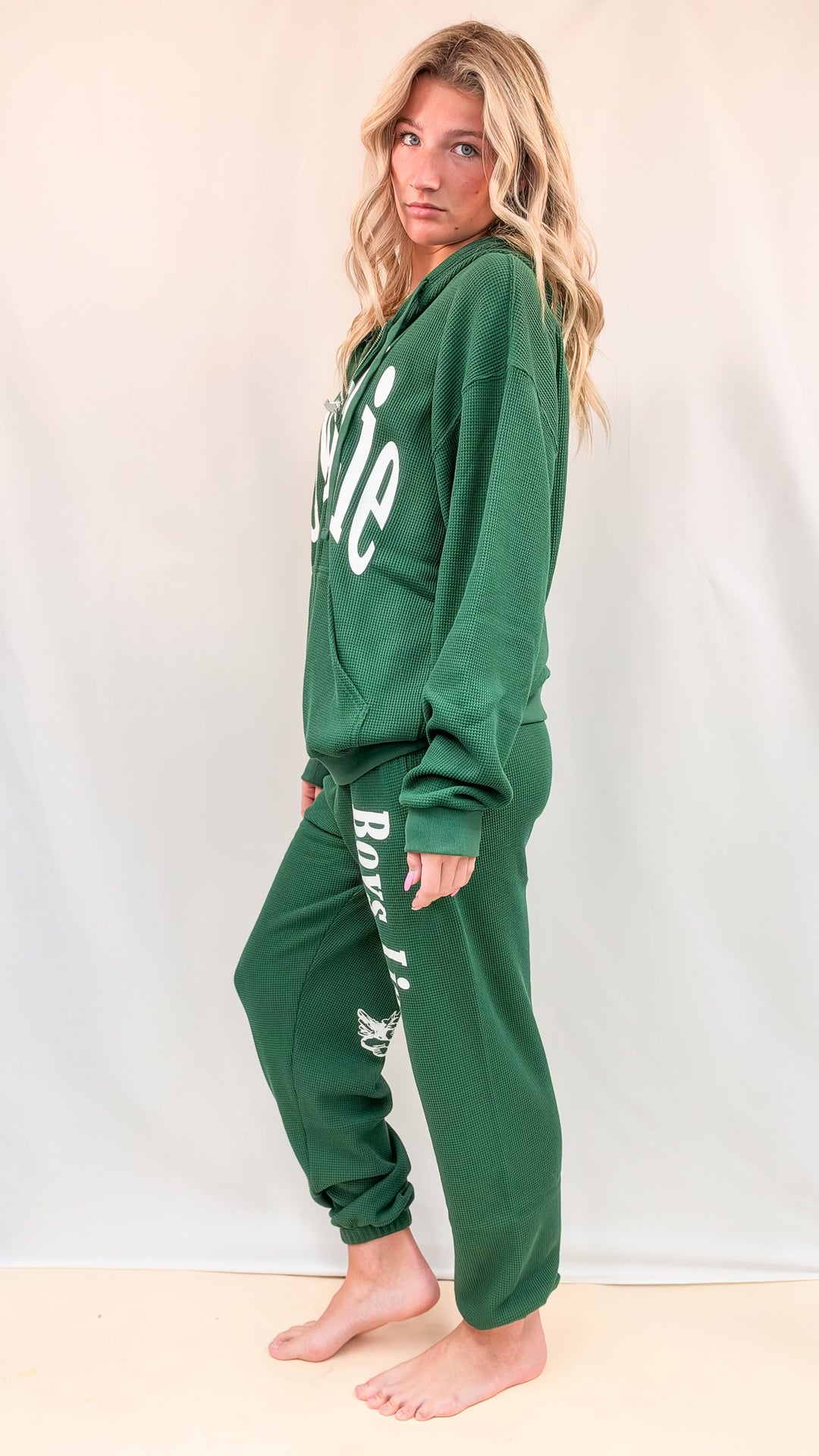 Woman wearing matching green set on plain background