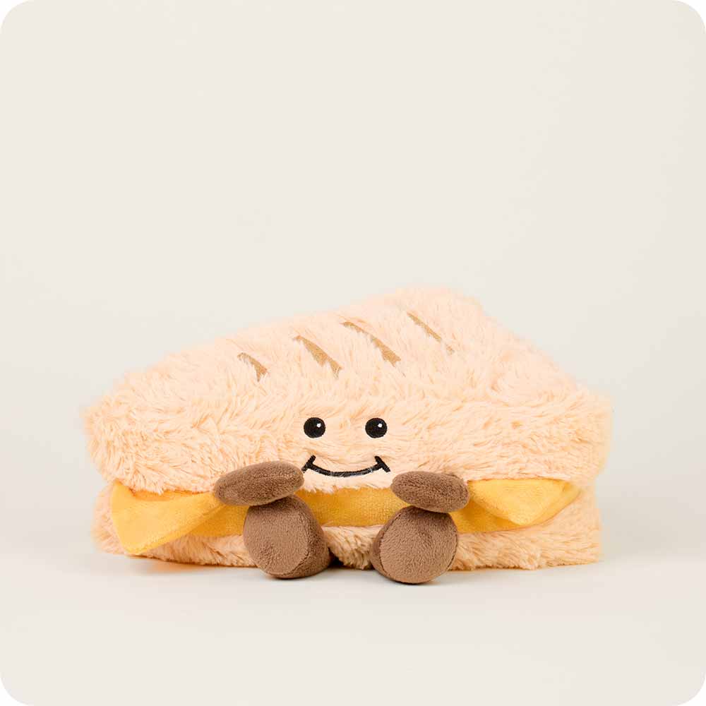 Plush toy shaped like a sandwiche with a smiley face on a white background