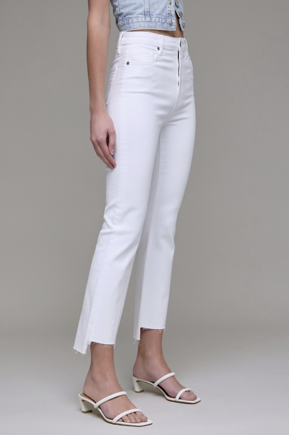 White pants worn by a person on a plain background