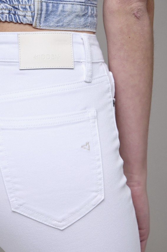 White jeans with a visible brand logo on a neutral background