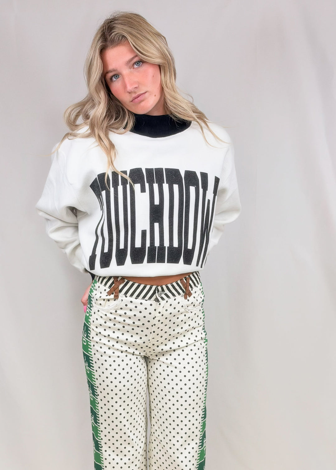Woman wearing black and white mock neck with &