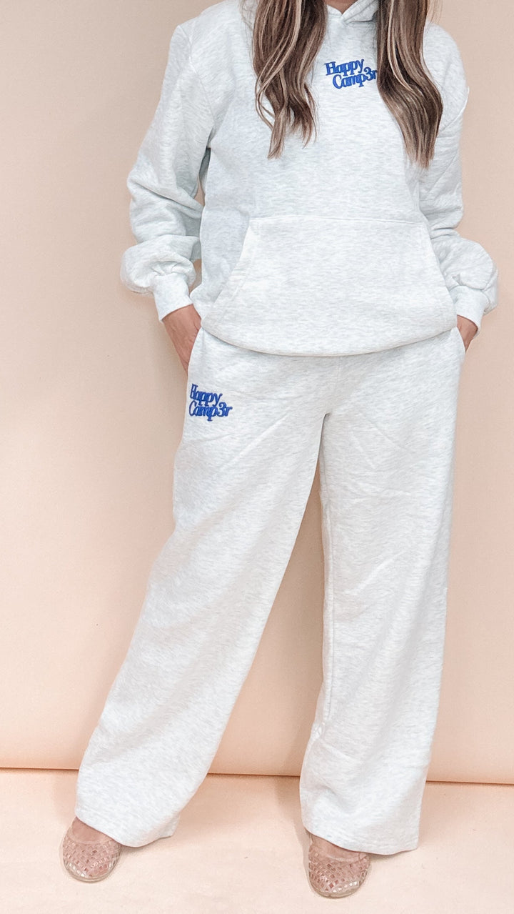 A person wearing a light heather gray lounge set with blue &