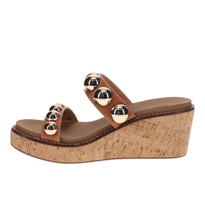 Brown wedge sandal with cork sole and gold embellishments on a white background