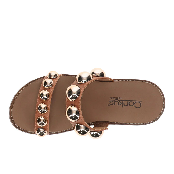 Brown sandal with gold embellishments on a white background