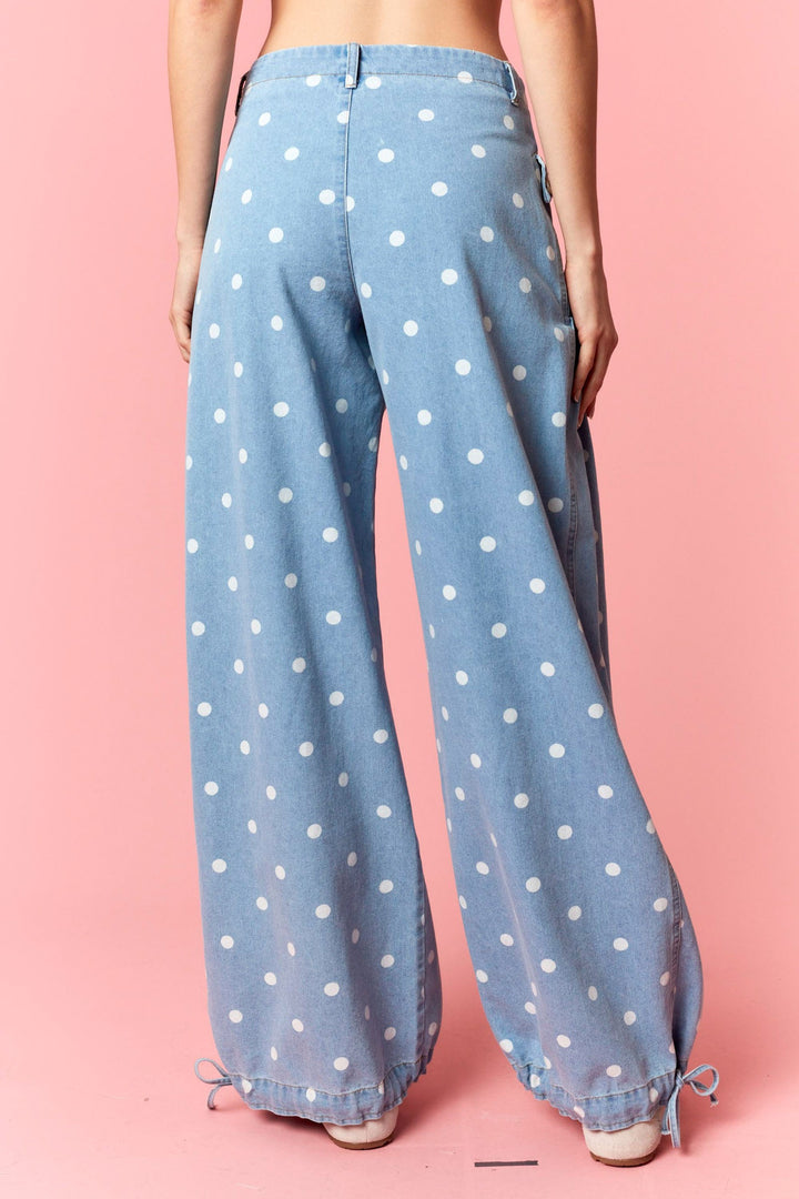 Light blue pants with white polka dots on a pink background
