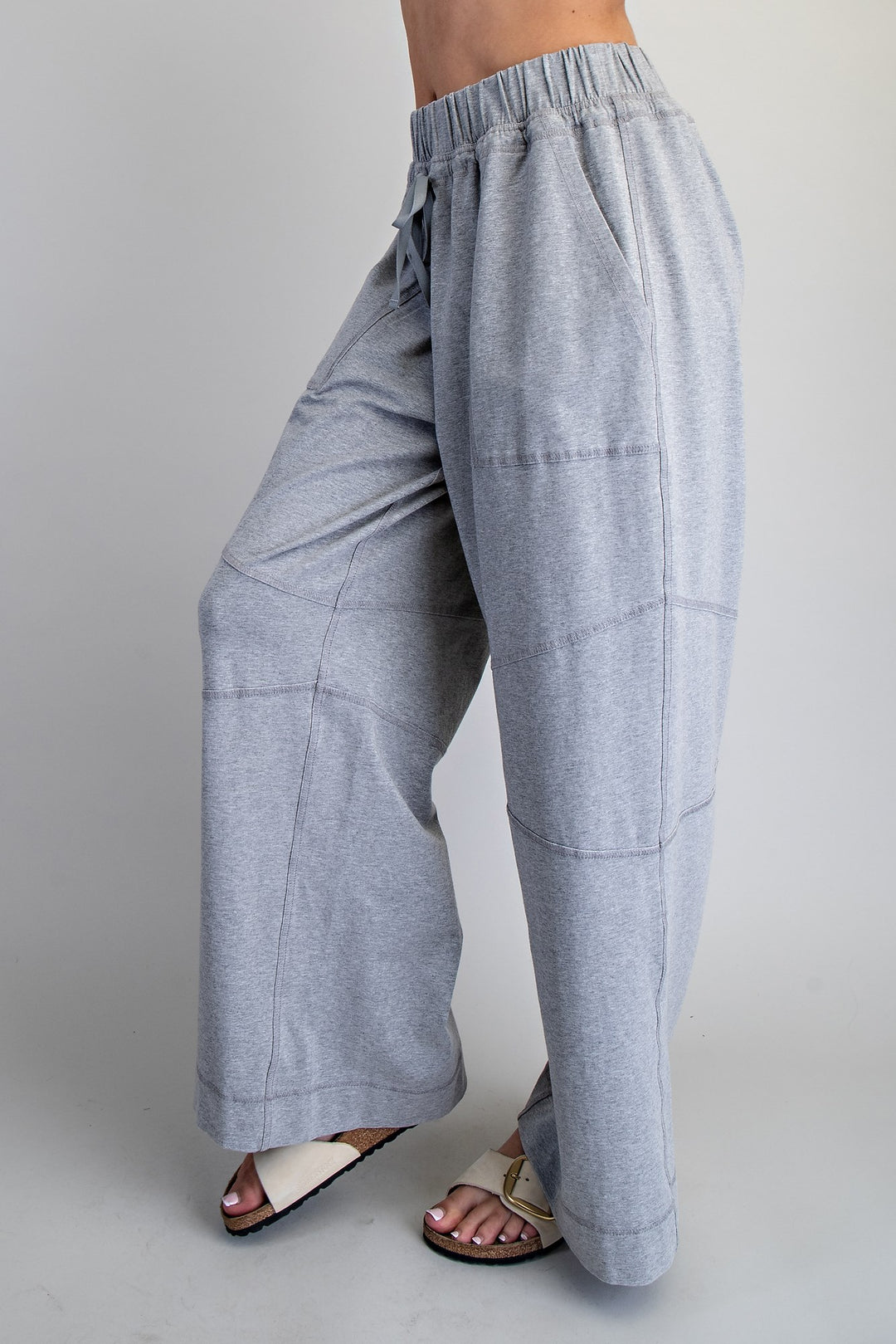 Light blue wide-leg pants worn by a person on a gray background