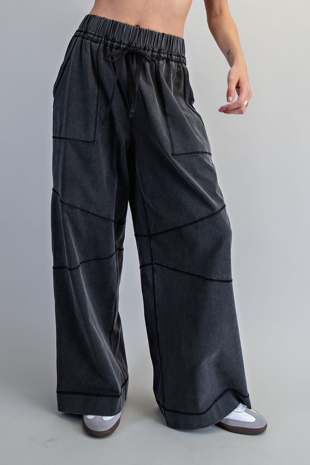 Black wide-leg pants worn by a person on a gray background