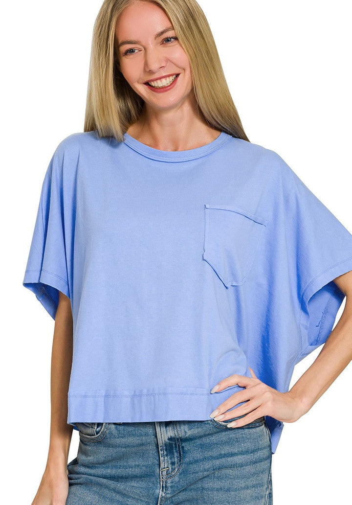 Woman wearing a light blue oversized t-shirt with a pocket on a white background