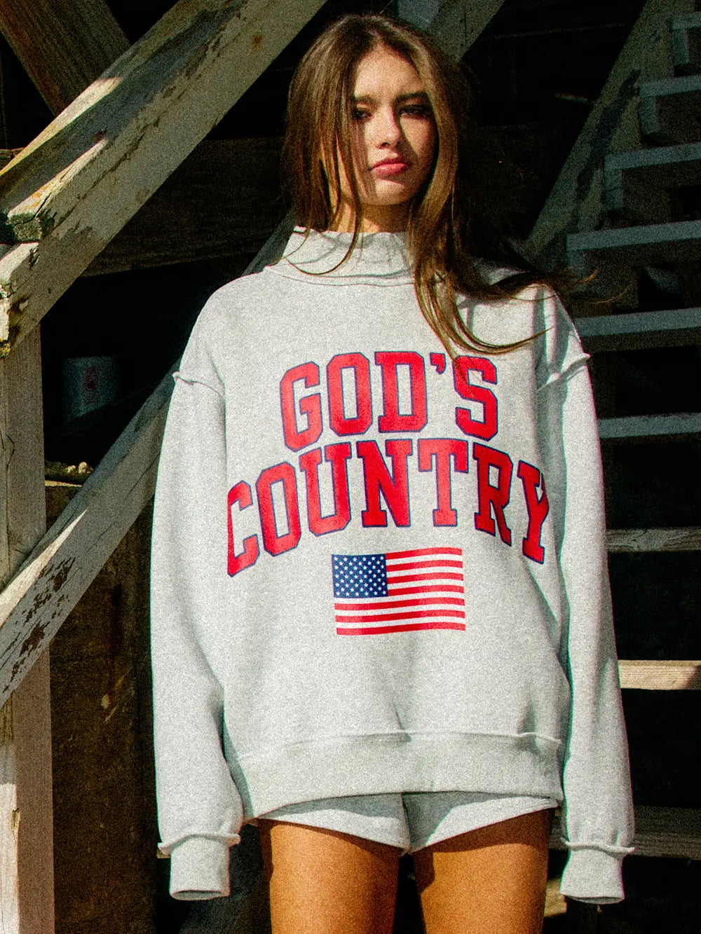 Person wearing a gray sweatshirt with &