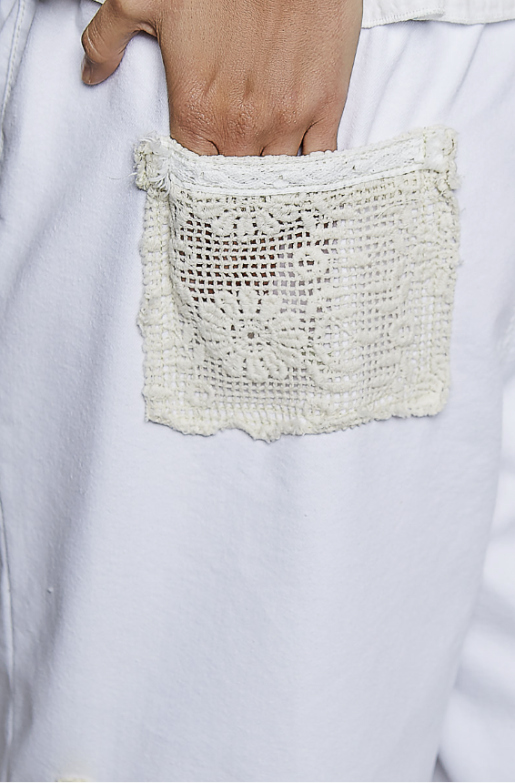 Close-up of a textured pocket on a light-colored garment