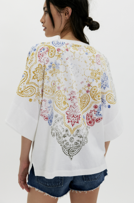 Woman wearing white tee and shorts on plain background