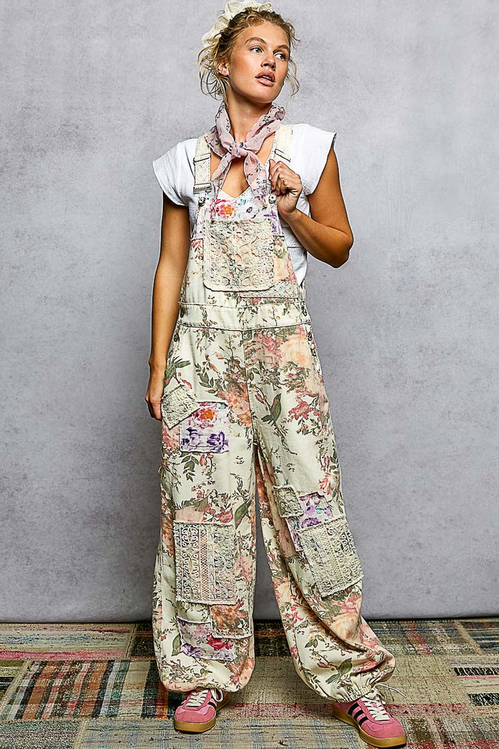 Woman wearing floral overalls on plain background