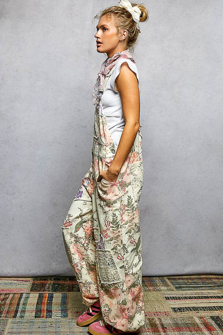 Woman wearing a floral overalls and pink shoes on a plain background