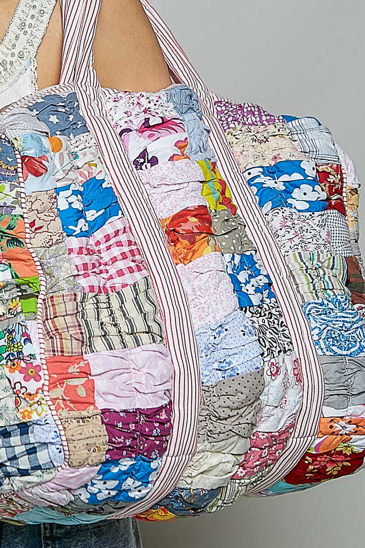 quilted bag on plain background