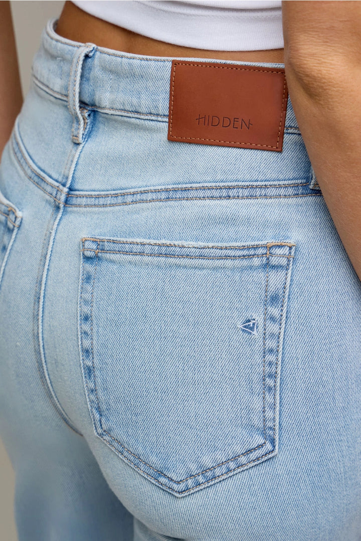 Light blue jeans with a brown leather patch and &
