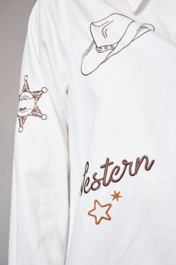 White shirt with cowboy hat, star, and 'Western' text design on a gray background
