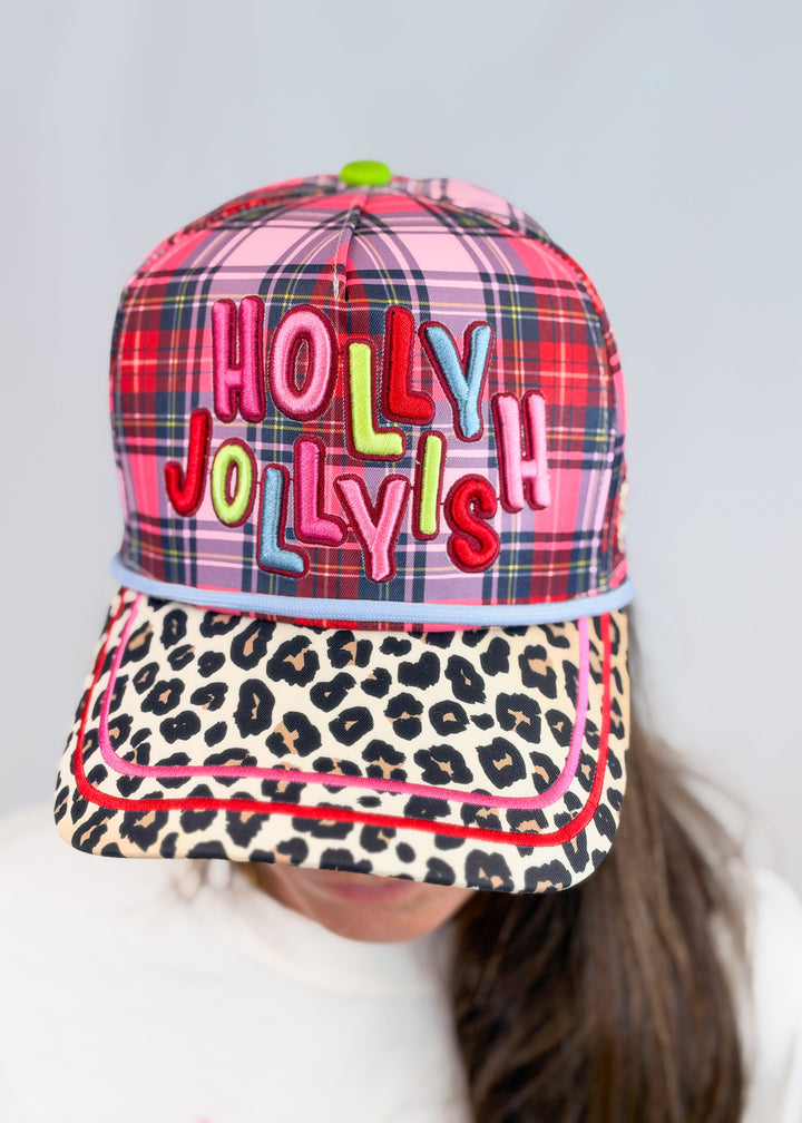Woman wearing pink, purple and red plaid hat with &