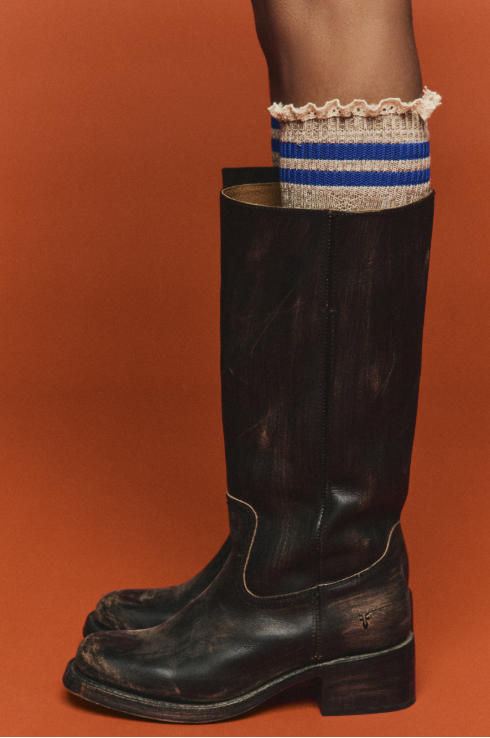 Woman wearing knee high socks in beige and blue with brown boots
