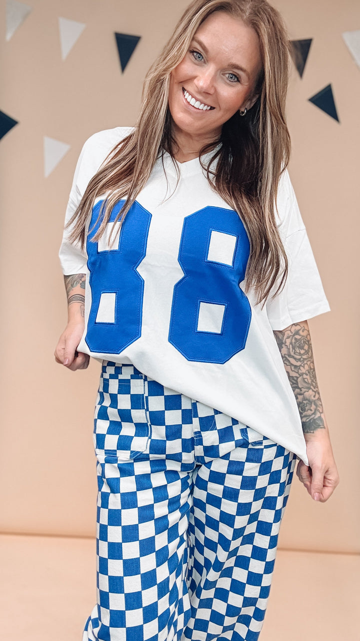 Woman wearing white tee with &
