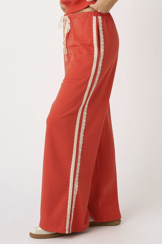 Red pants with white stripes on a white background