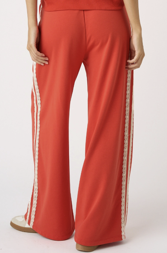 Red pants with white stripes on a white background