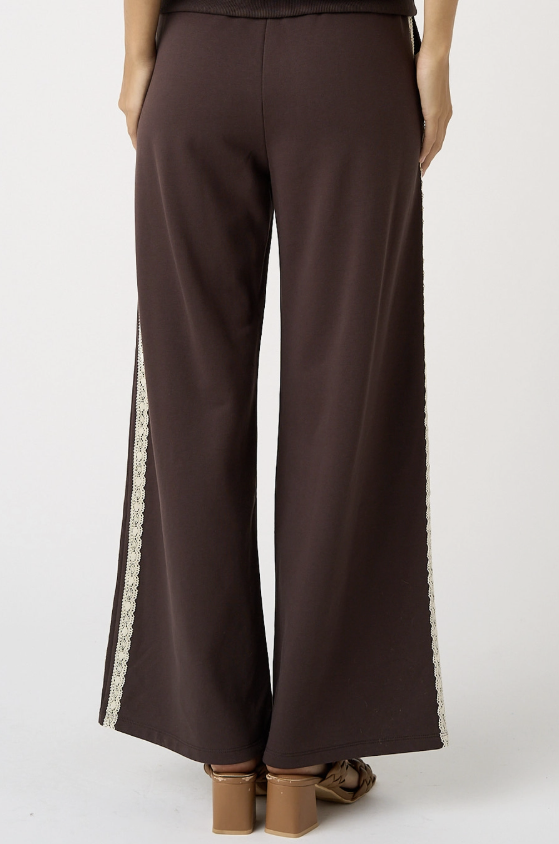 Brown pants with lace trim on a white background
