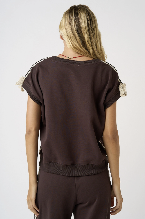 Woman wearing brown tee on white background