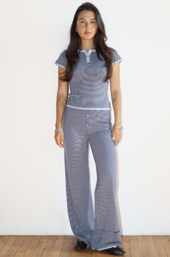 Woman wearing a patterned outfit on a plain background