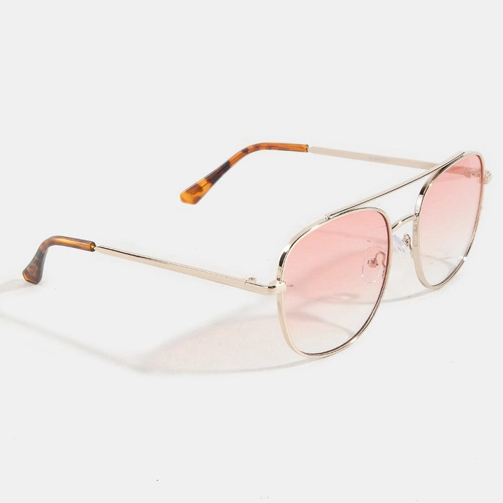 Sunglasses with gold frame and pink lenses on a white background