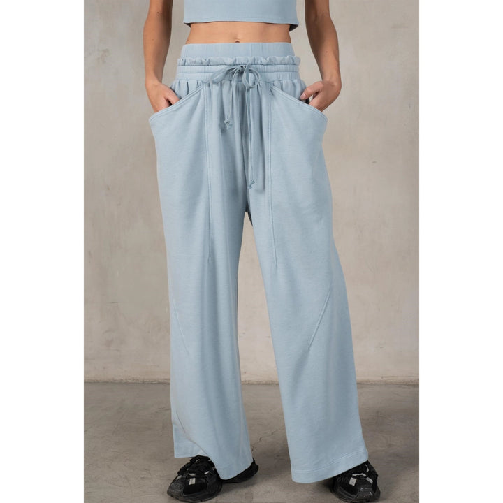 Light blue pants worn by a person against a neutral background
